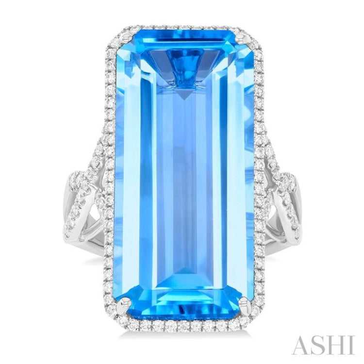 26x12 MM Emerald Cut Blue Topaz and 1/2 Ctw Round Cut Diamond Halo Semi-Precious Ring in 14K White Gold