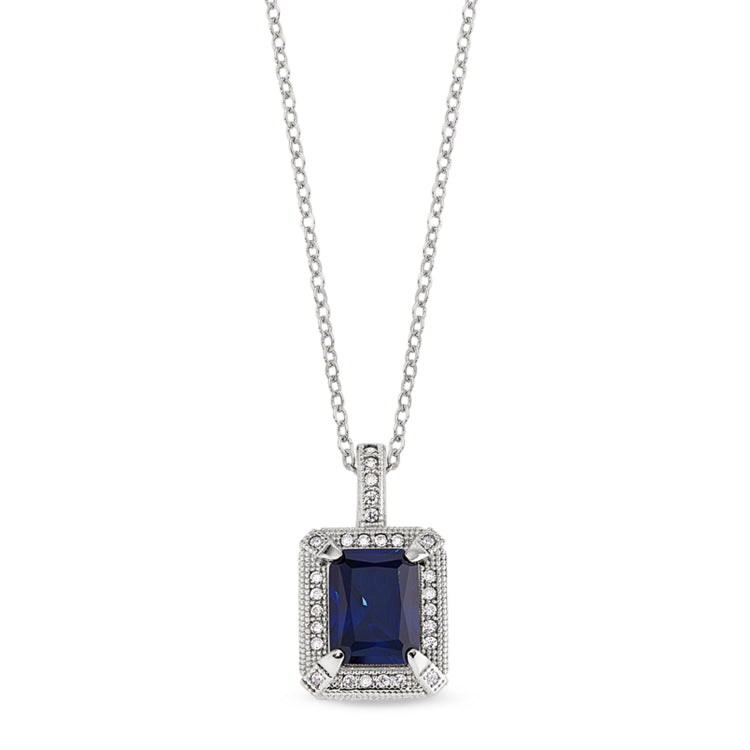 Platinum finish sterling micropave emerald cut synthetic blue corrundum pendant with simulated diamonds on an 18 cable chain